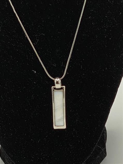 <b>Lia Sophia Pendant</b> Gold Tone Mother of Pearl Abalone Shell Asymetrical. . Lia sophia pendant